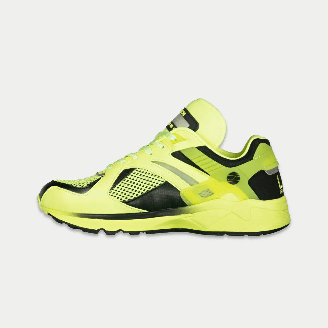 Neon yellow shoe with black accents on a white background
