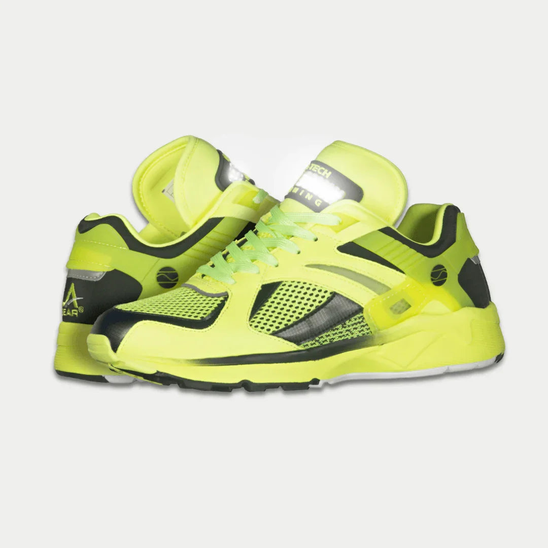 Neon yellow shoes with black accents on a light gray background