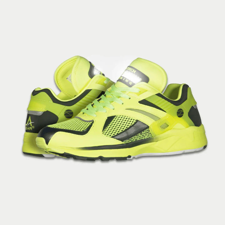 Neon yellow shoes with black accents on a light gray background