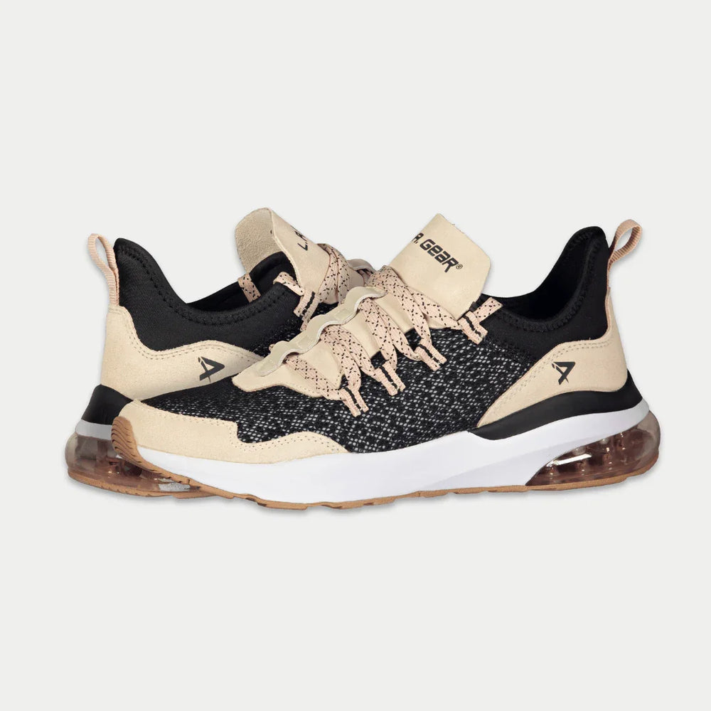 Black and pink sneakers with a brand logo on a light gray background